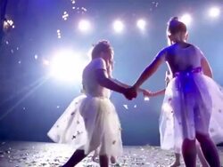 Medium shot four young ballerinas in tutus holding hands and circling on stage / twirling in place Stock Footage