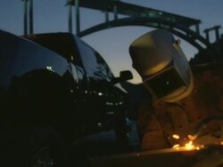 MS Man arc welding next to truck beside under construction bridge at Hoover dam / Mojave, California, USA Stock Footage