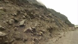 A bus pulls to a stop on a rough mountain road in the Andes. Stock Footage