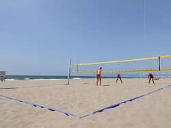 WS Establishing master shot of female beach volleyball players, showing the whole court,  jump serve ace. Stock Footage