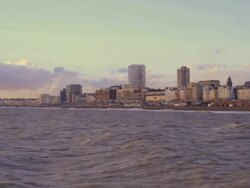 Tourists walk on the beach near Brighton Pier Stock Footage
