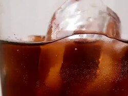 Close up of rotating Cola with ice Stock Footage