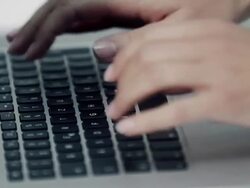 Woman typing on laptop Stock Footage