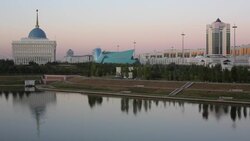 Central Asia, Kazakhstan, Astana, View of city reflecting in Isahim River and Ak Orda Presidential Palace Stock Footage