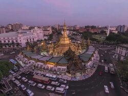Asia, Myanmar, Yangon, elevated view of skyline and Sule Pagoda, in middle of road intersection, day to night Stock Footage