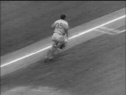 B/W 1955 Brooklyn Dodger Roy Campanella batting + running to second base / World Series Stock Footage