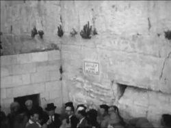 B/W 1967 tilt down Wailing Wall to crowd gathered to celebrate after Six Day War / Jerusalem / newsreel Stock Footage