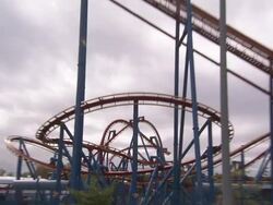 Storm clouds loom above an empty roller coaster. Stock Footage