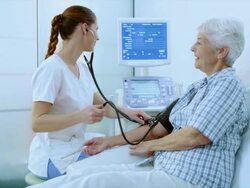 Nurse measuring a womans blood pressure Stock Footage