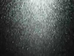 CU SLO MO Shot of Wide spray of water moving through frame against black background / United Kingdom Stock Footage