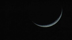 A crescent moon glows in a dark sky. Stock Footage