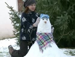 MS Girl making   snowman / Saarburg, Rhineland-Palatinate, Germany Stock Footage