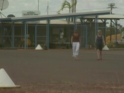 Passengers walking from terminal, Maningrida airport, Australia Stock Footage