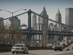 Traffic speeds down the FDR Highway in New York City the Manhattan Bridge and the Downtown Skyline are featured. Stock Footage