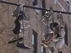 Sneakers hanging from electrical wire Stock Footage