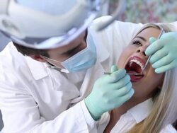 Male dentist examining a female patient. Stock Footage