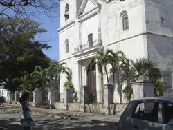 Central Square and church and traffic in Santiago de Las Vegas Cuba Stock Footage
