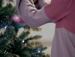 Young girl hanging Christmas decorations Stock Footage