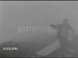 1951: WHAT-IF SCENARIO: SYRACUSE 'AFTER': WS Dump w/ door on ground, person running through smoke, mist, fog. WS Smoke, mist, fog flowing into residential area, person in hardhat jumping fence, running.  1950s Horror, 1950s Sci-fi, Red Scare. Instructional Video