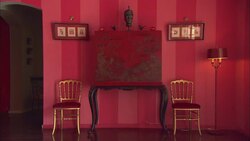 Chairs and paintings flank an ornate bureau in La Maison Hotel in Rio de Janeiro. Stock Footage