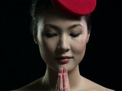 Woman wearing red hat with hands together Stock Footage