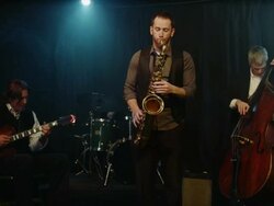 Medium shot of man playing saxophone on stage with musicians / Provo, Utah, United States,  Stock Footage