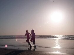 Jogging at the beach Stock Footage