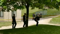 Plain clothes officers walking towards crime scene Stock Footage