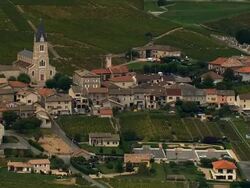 AERIAL WS Vineyards surrounding church and town in rural landscape / Beaujolais Region, France Stock Footage