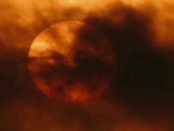 Extreme large Sun showing sunspots with dark clouds passing in forground Stock Footage
