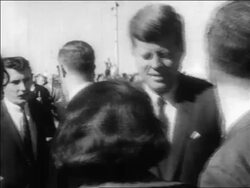 B/W 1963 President John Kennedy talking to someone outdoors / Dallas / newsreel Stock Footage