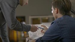 CU Businessmen sorting papers in the office late at night. Stock Footage