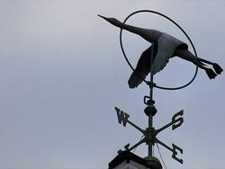 Weathervane against blue sky Stock Footage