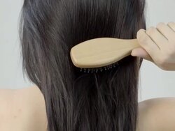 Woman combing her long hair with hairbrush Stock Footage