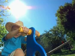 HD Super Slow-Mo: Little Cowboy Riding A Spring Horse Stock Footage