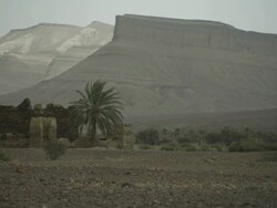 Building remains are overlooked by imposing, North African mountains. Stock Footage