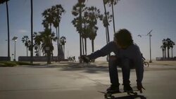 dolly of skater filming himself with phone in venice California skatepark Stock Footage