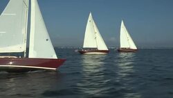 Three red hulled Morris M Series sailboats sail in tandem in Narragansett Bay. Stock Footage