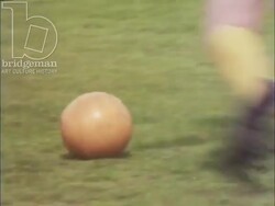 Living at Thamesmead, 1973, part 4 - Couple sitting on the grass, and flashbacks to a football game Stock Footage