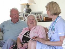 Retired Senior Couple Having Health Check With Nurse At Home Stock Footage