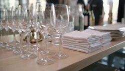 Wine glasses, napkins and plates on buffet table Stock Footage