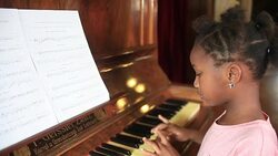 Young girl playing Piano Stock Footage