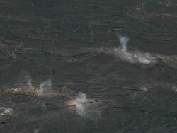 CU Shot of volcanic steam rising from vent in black lava field on Kilauea Iki Crater trail in Volcanoes National Park / Volcano, Hawall, Big Island, United States Stock Footage