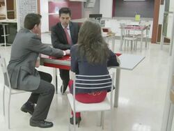 TS WS  kitchen salesman and young couple seated at desk discussing plans Stock Footage