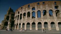 Tourists stroll along the exterior perimeter of Rome's ancient Colosseum. Stock Footage