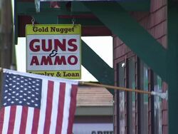 Guns and Ammo Sign Outside Store News Clip