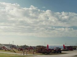Drive by of a tractor dealership in small rural town Stock Footage