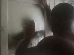 MS  Young man standing in  bathroom with his shrit off and  looking into mirror with filled steam / Minneapolis, Minnesota, United States Stock Footage
