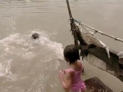 MS TU Two girls jump into polluted river  / Surabaya, East Java, Indonesia  Stock Footage