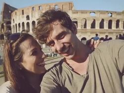Tourist couple taking a selfie in front of the Coliseum Stock Footage